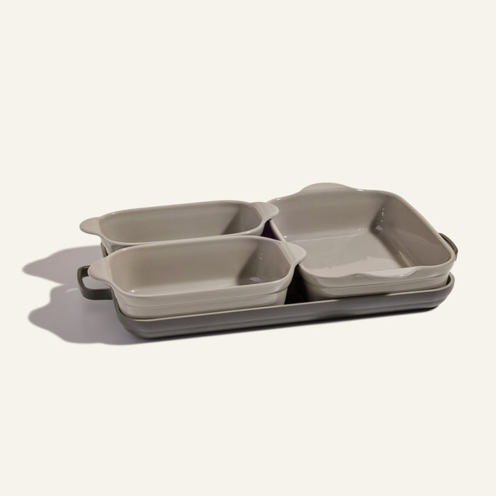 The Bakeware Set includes four rectangular ceramic baking dishes in different sizes, stacked neatly on a light background—ideal for enhancing your oven cookware collection.