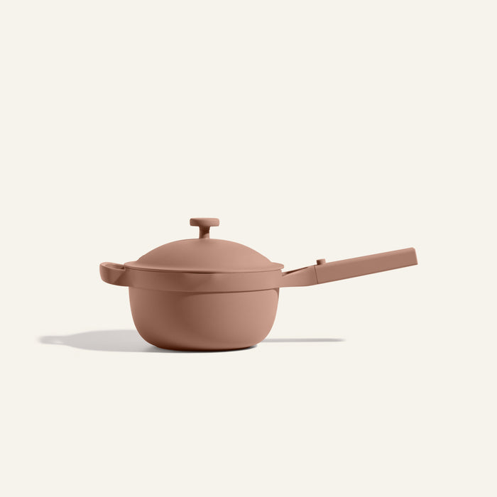 The Mini Perfect Pot 2.0 is a matte, light brown nonstick pot with a long handle and lid, displayed on a plain off-white background.