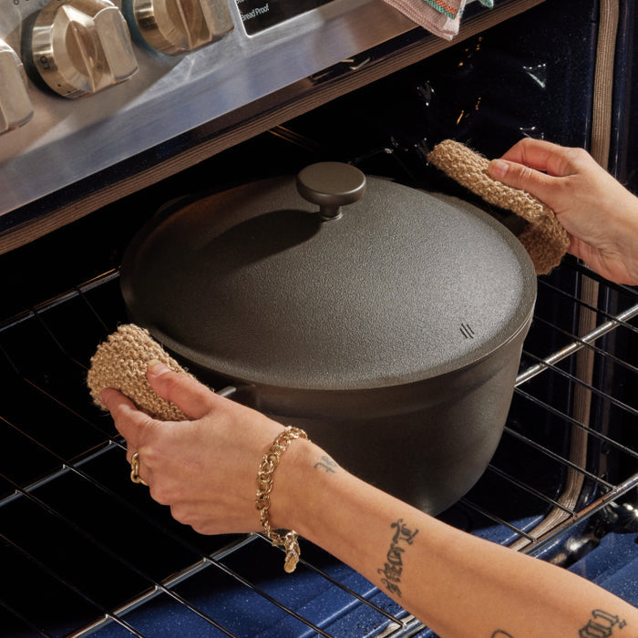 Removing a black perfect pot non toxic nonstick dutch oven from the oven
