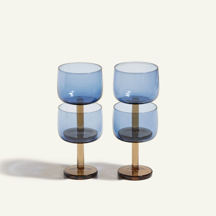 Four Party Coupes with blue bowls and gold stems, part of a stylish beverage set, are arranged in two vertical stacks against a plain light background.