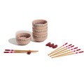 The Rice Bowl Set includes four pink patterned stoneware bowls, matching chopsticks with red and white tips, and red rests—ideal for your Lunar New Year table setting.
